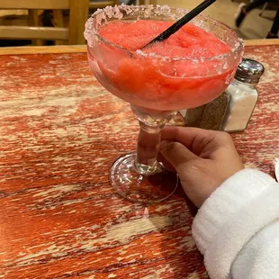 a person holding a glass of watermelon
