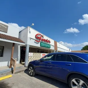 a car parked in front of a restaurant