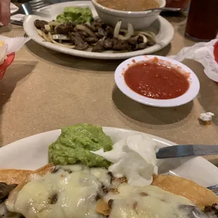 Fajita nachos and beef fajita plate with borracho beans.