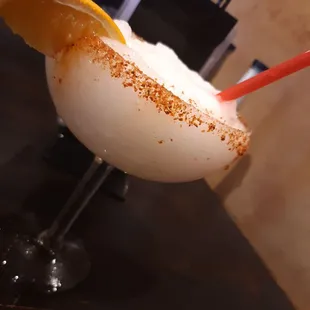 a drink with a slice of orange on the rim