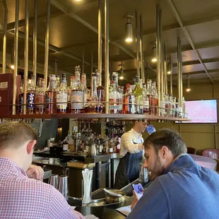 two men sitting at a bar