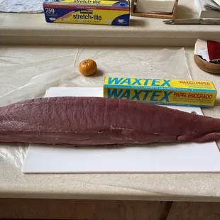 a piece of raw tuna on a cutting board