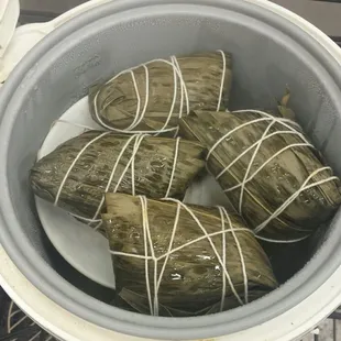 "Chinese tamales" warm in the rice maker in front of the cash register.