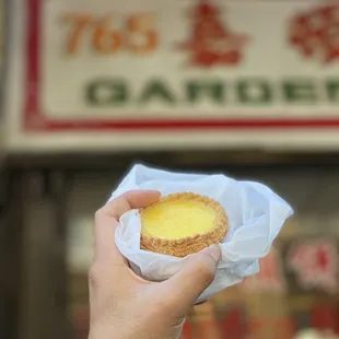 a hand holding a pastry