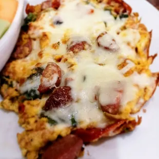 Mardi Gras scrambler with smoked sausage oven, roasted tomatoes, spinach and provolone cheese.