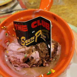 a bowl of ice cream with a sign in it