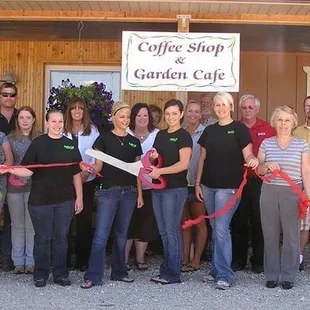 group of people cutting ribbon