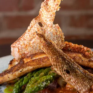 a plate of grilled fish and asparagus