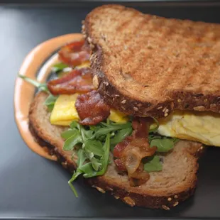 Breakfast Panini with Bacon and Arugula
Egg, arugula, cheddar, bacon and sriacha aioli