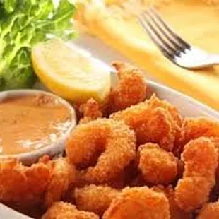 a plate of fried shrimp with dipping sauce