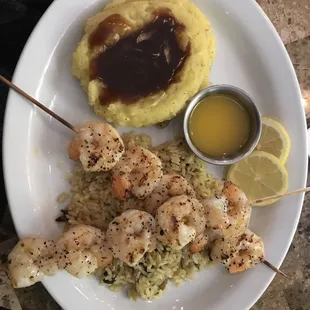 delicious grilled shrimp served on a bed of brown steamed rice. Paired with mashed potatoes and brown gravy. It was amazing