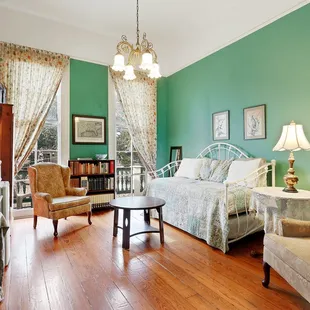 One of the Balcony Suites with queen bed, sitting room with 2 twin beds (trundle) and private bathroom with claw foot tub/shower