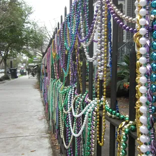 Mardi Gras beads on the fence