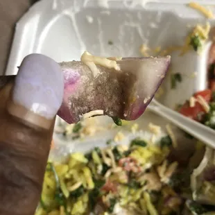 a hand holding a piece of food