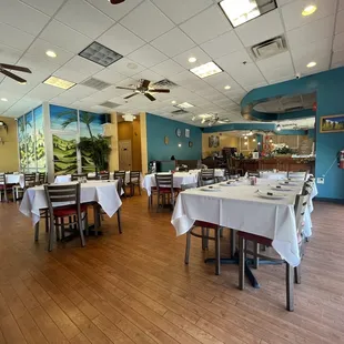 tables and chairs with white tablecloths