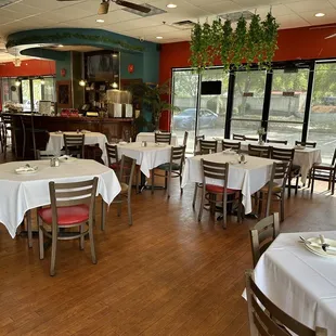 tables and chairs with white tablecloths