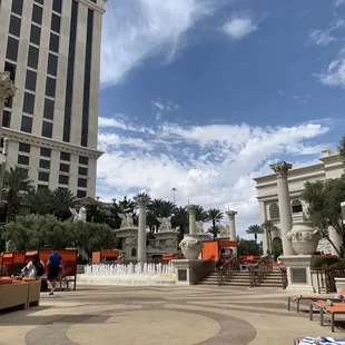 a fountain and lounge chairs