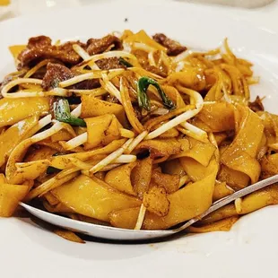 a plate of pasta with meat and cheese