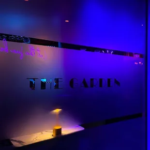 the neon sign for the garden
