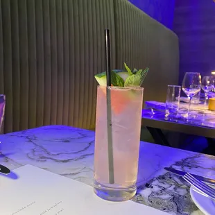 a table with a drink and menu