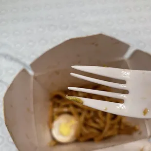 a fork in a box of noodles