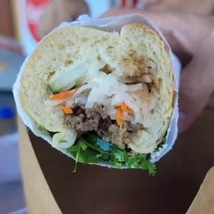 a woman holding a sandwich