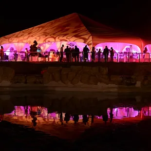 Night time view of the Grand Marque with reflection from our pond