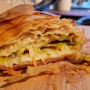 Interior of leek lemon garlic boughatsa ($8), vegan by default. Nice shell, but interior was wet and flavorless.