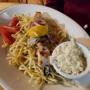 Chicken Kabab on linguini with a bowl of shredded sheep&apos;s cheese