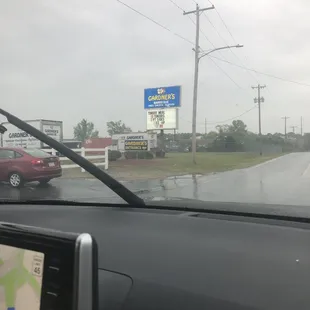 a view of a gas station from inside a car