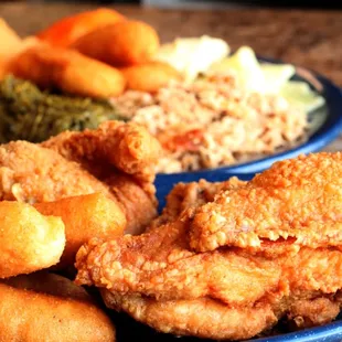 a plate of fried chicken and other foods