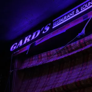 a neon sign for a restaurant and lounge