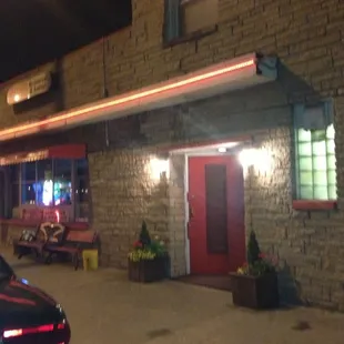 Gards is a triangular lot with a tent covered outside patio with seating.