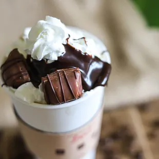 a cup of coffee with whipped cream and chocolate