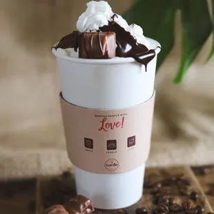 a cup of coffee with whipped cream and chocolate