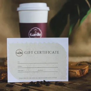 a gift certificate and a cup of coffee
