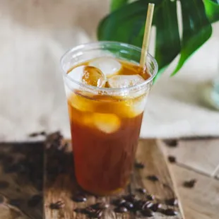 a glass of iced coffee with a straw
