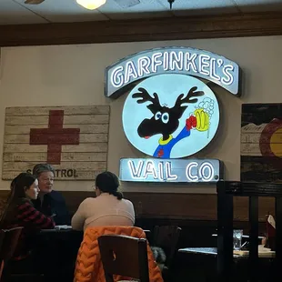 people sitting at tables in a restaurant
