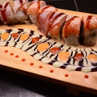 wow roll shrimps tempura spicy sauce unagi top with fresh salmon and tuna flame torch and top with unagi sauce