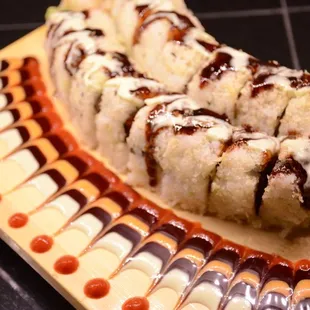 Godzilla roll shrimps tempura,crab,avocado spicy sauce,cream cheese top with wasabi mayo and unagi sauce