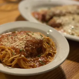 two plates of spaghetti and meatballs