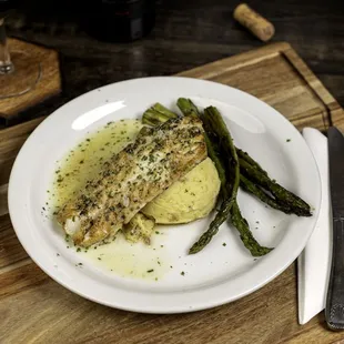 a plate of fish and asparagus