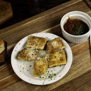 a plate of food and a bowl of sauce