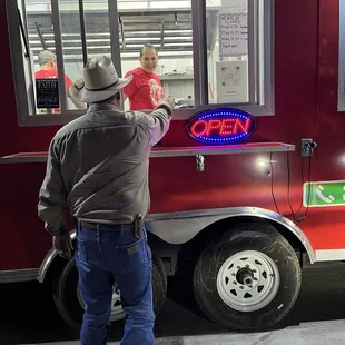 The Boss Lady happily serving her customers! Get it girl!