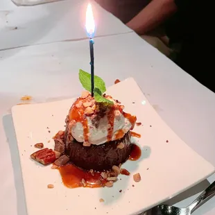 Chocolate dessert with a birthday candle on top for our friend, N.