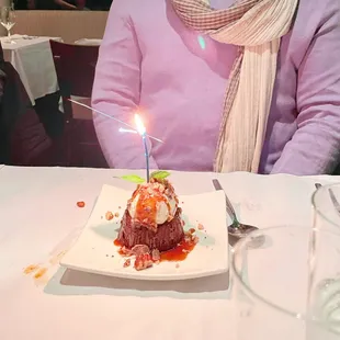 Birthday cake in front of our friend. He was careful to blow out the candle as the place was packed!