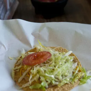 a taco with lettuce and tomatoes