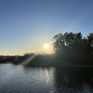 the sun setting over a lake