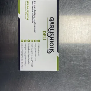 a business card on a stainless steel surface