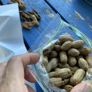 a person holding a bag of peanuts